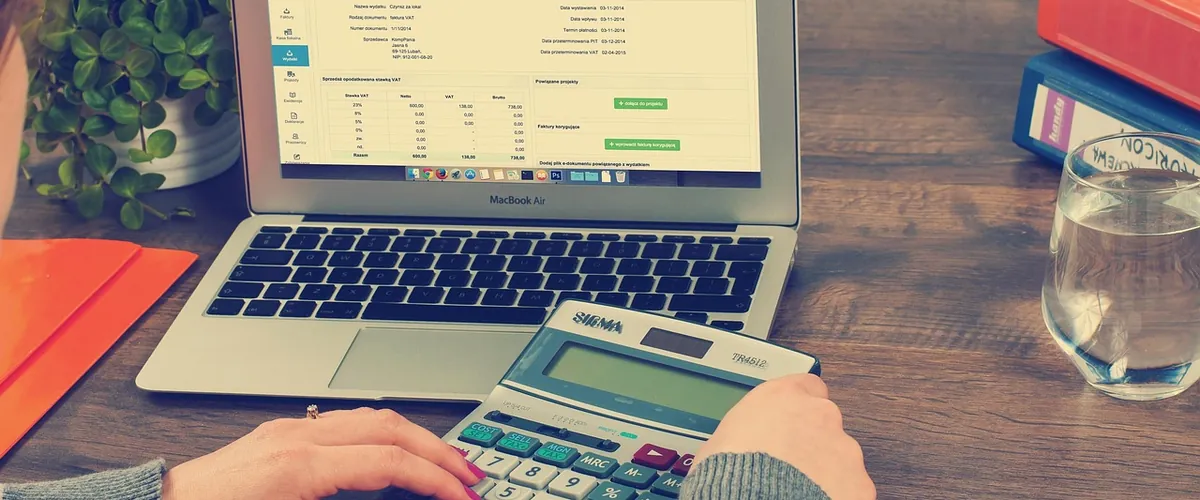 An accountant's desk with laptop and figures, where we automate data entry and reporting