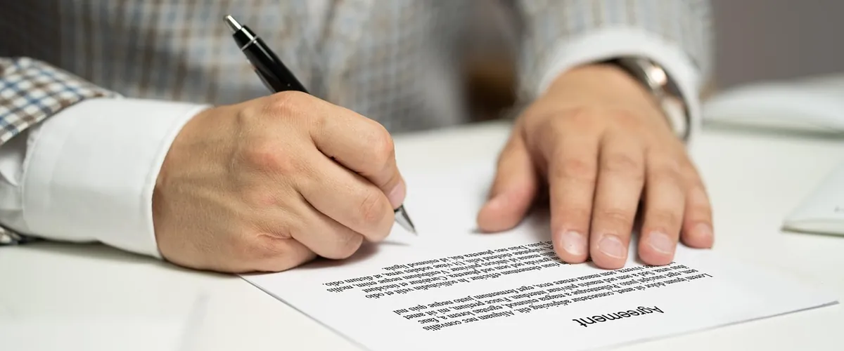 Signing legal documents at a solicitor's desk, the conveyancing admin we help automate